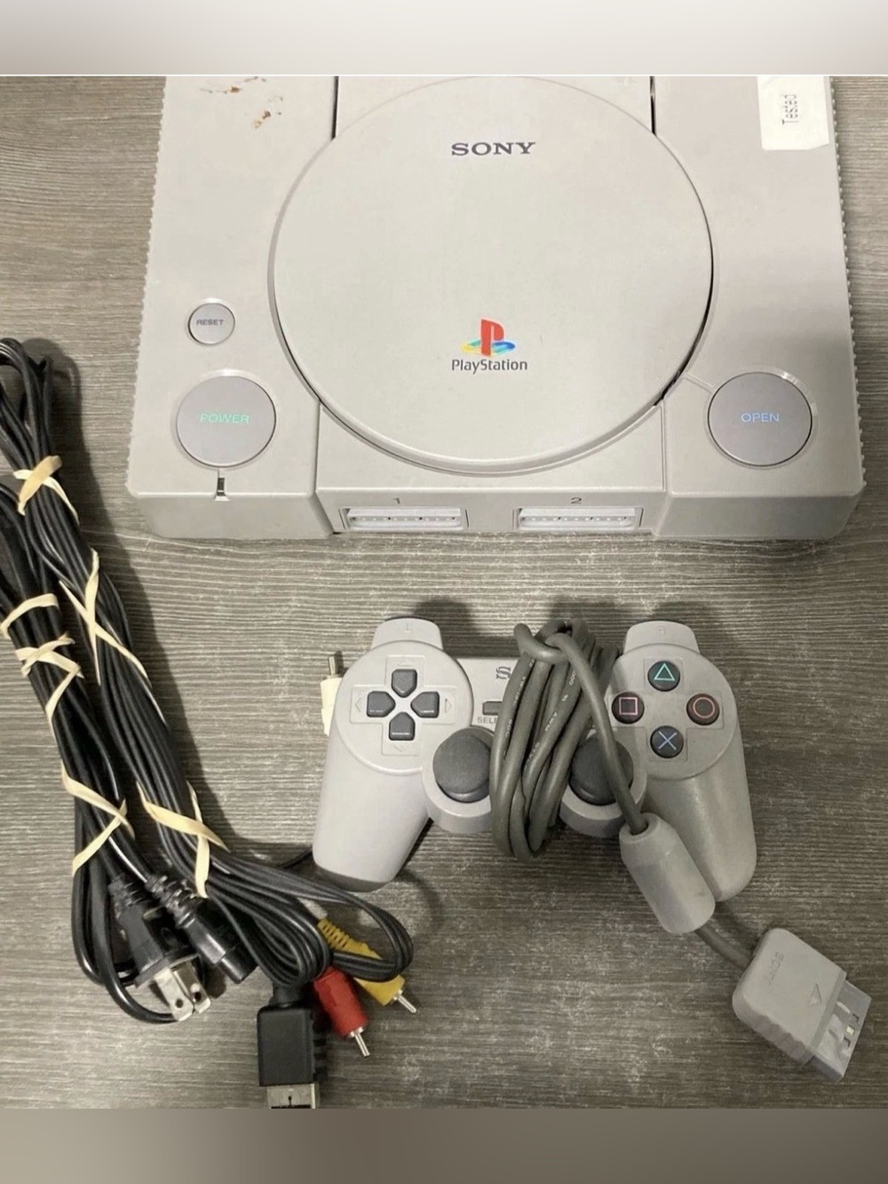 Sony Gray PlayStation Console with Matching Gray Controller and Cables